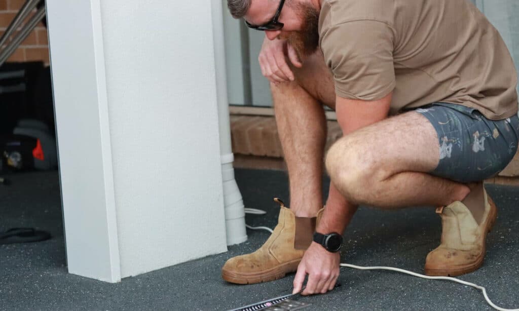 Tardesman Installing Lauxes Grates On The Floor